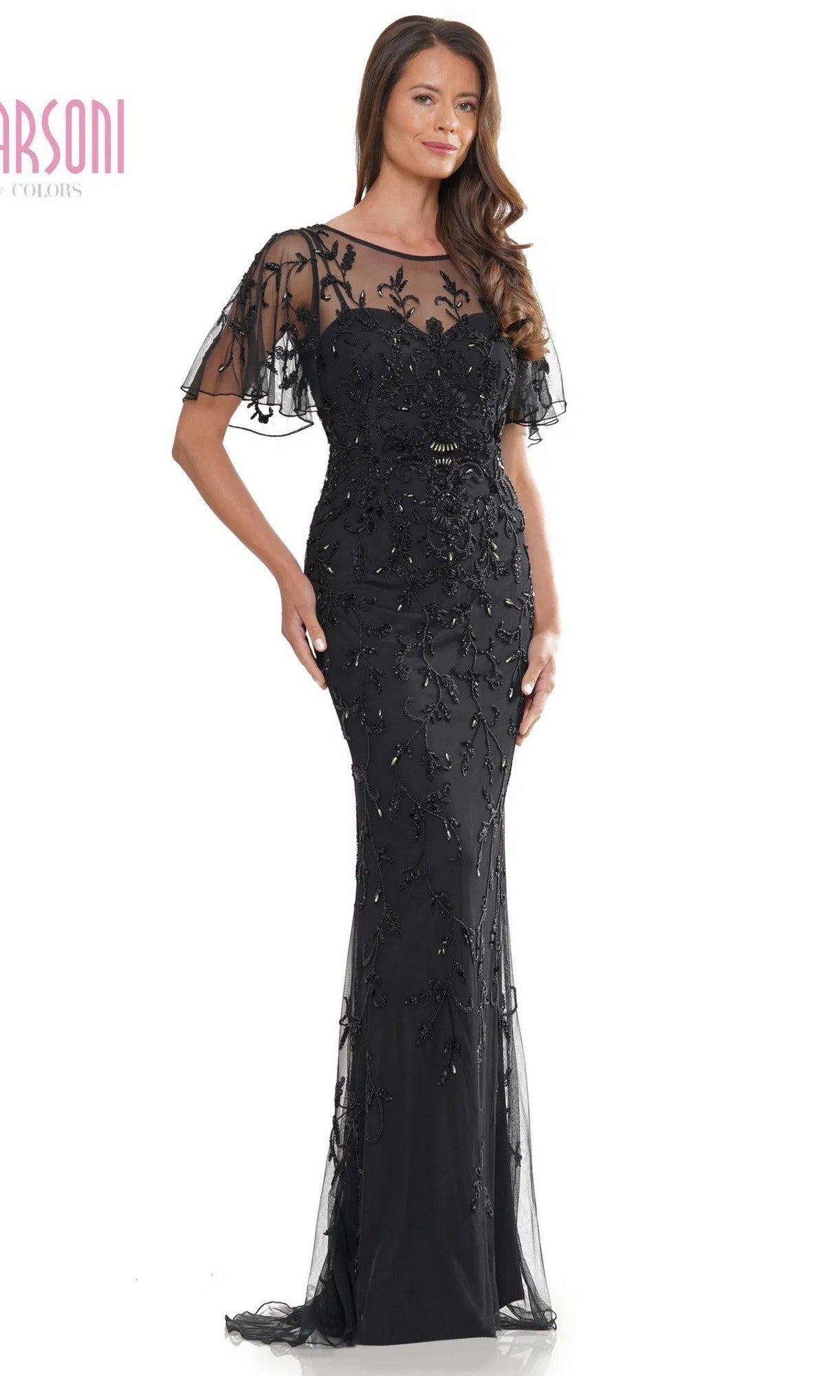 A woman stands facing forward against a white background, wearing the Marsoni MV1281 long formal dress in black, featuring sheer sleeves and floral embellishments.